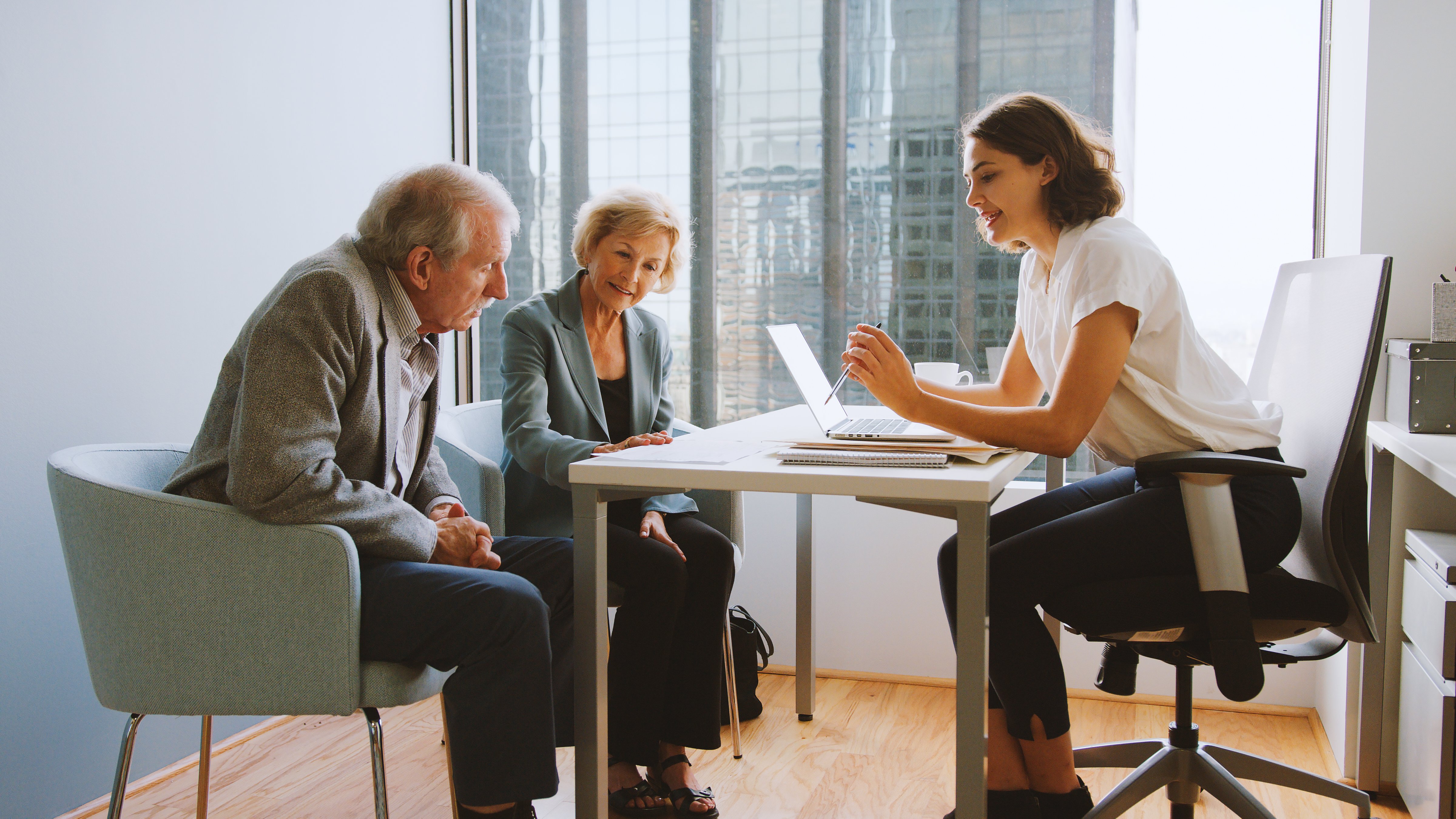 Senior Couple Meeting With Female Financial Advisor In Office